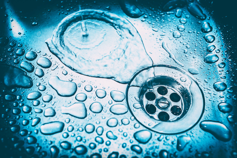 water drops in the kitchen sink close up - blue toned image